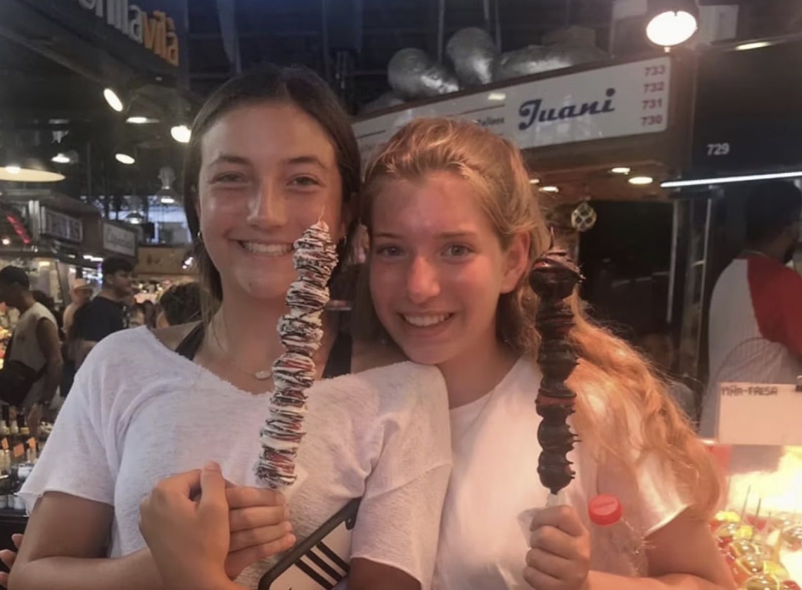 Two players with chocolate treats at a market